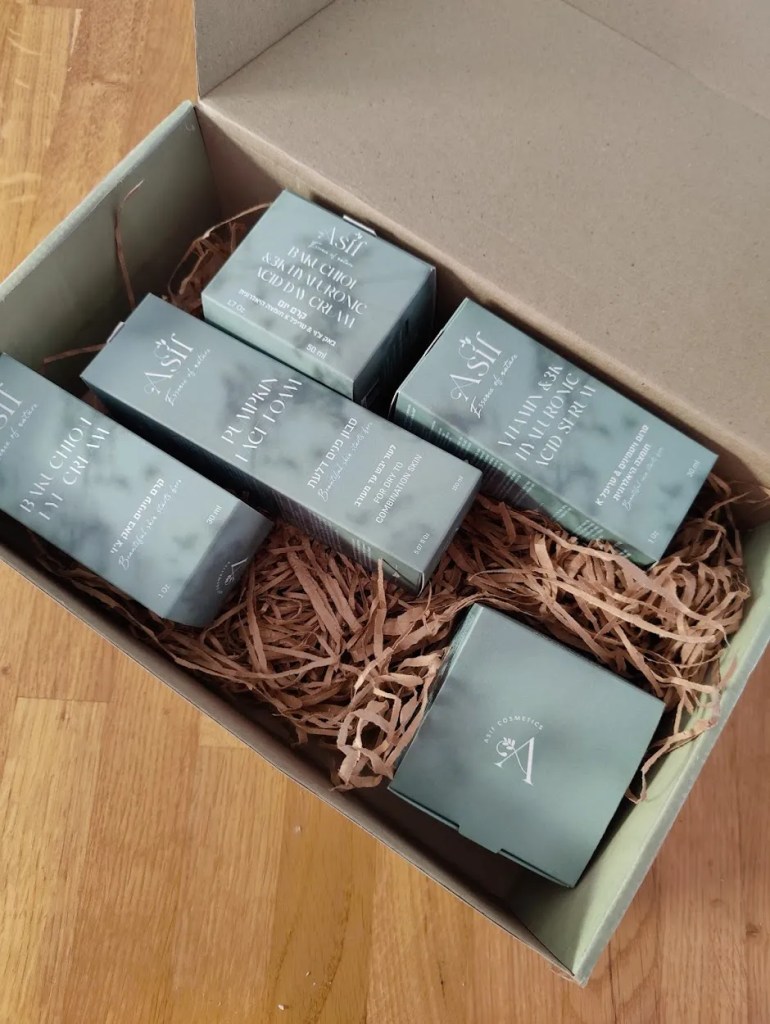 A neatly packed box containing various skincare products from Asif Cosmetics, featuring elegant packaging with a natural aesthetic.