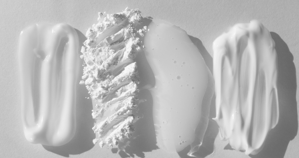 A variety of cosmetic product textures, including cream, powder, gel, and lotion, displayed in white against a light background.